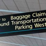 Airport sign for Baggage Claim and other destinations.