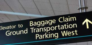 Airport sign for Baggage Claim and other destinations.