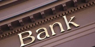Gold bank sign on building facade