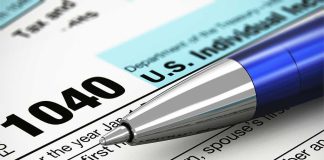 Close-up of a U.S. IRS 1040 tax form with a blue pen