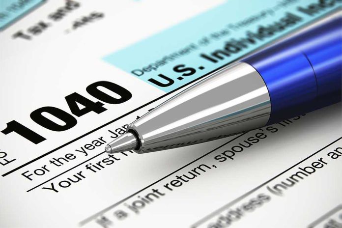 Close-up of a U.S. IRS 1040 tax form with a blue pen