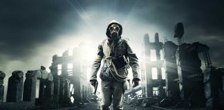 A lone figure in a gas mask walks through a desolate, ruined urban landscape