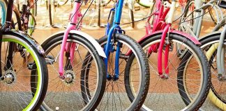 A row of colorful bicycles parked, showcasing their wheels and frames