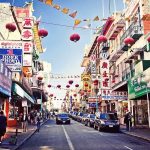 A bustling street in Chinatown adorned with colorful lanterns and signs