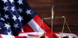 Scales of justice with American flag background.