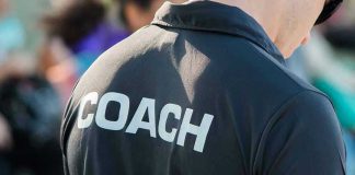 Person wearing a shirt labeled Coach.