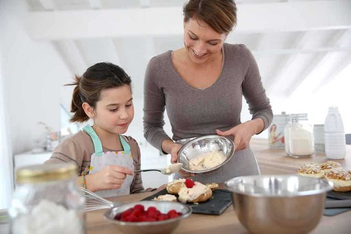 A mother and daughter baking together in a bright kitchen