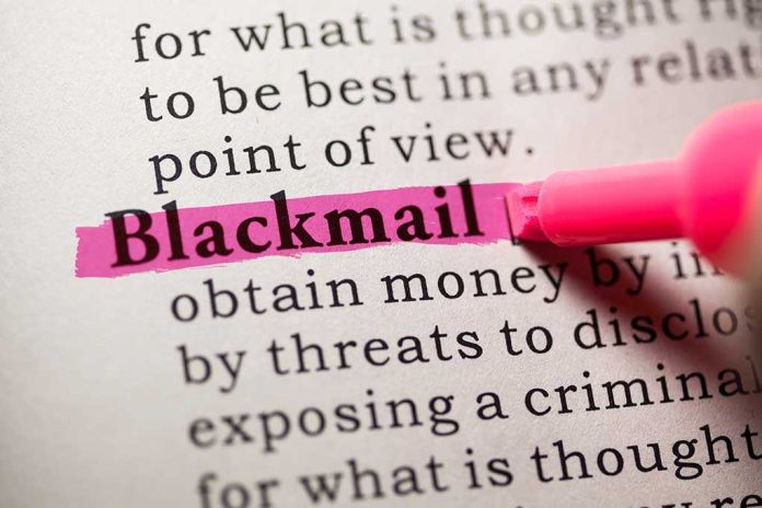 shutterstock_181197875.jpg Close-up of a dictionary page with the word blackmail highlighted in pink