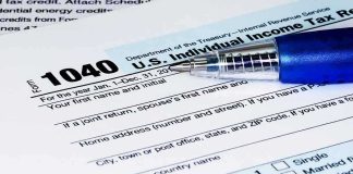 Close-up of a U.S. Individual Income Tax Return form 1040 with a pen