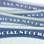 Several Social Security cards stacked together.