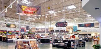 Supermarket interior with various food sections and displays.