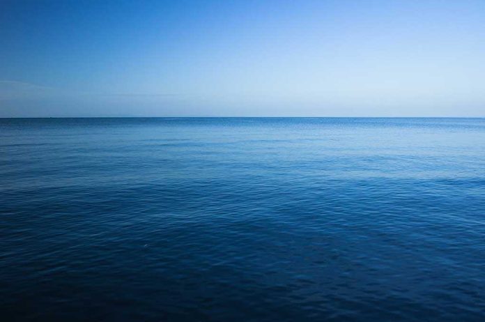 shutterstock_229991677.jpg A calm ocean under a clear blue sky