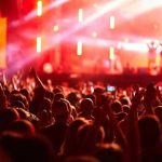 Crowd at concert with vibrant stage lights.