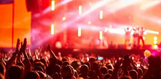 Crowd at concert with vibrant stage lights.