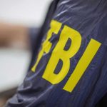 Jacket with FBI letters in yellow.