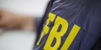 Jacket with FBI letters in yellow.