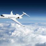 Private jet flying above the clouds.