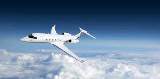 Private jet flying above the clouds.