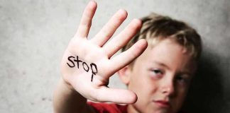 HORRIFYING Discovery: Kids Smuggled For Cartel Profit A child holding up a hand with the word stop written on it