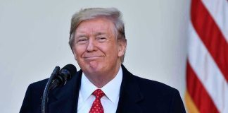 Trump’s ‘Bad Timing’ Stuns: Iran Over Family? Man in suit and tie speaking at podium.