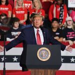 Trump’s Bold Praise for Xi: What’s Behind It? Person speaking at podium with crowd behind them.