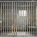 Iran’s Execution: Shocking CIA Link? Empty rusty prison cell with a small window.