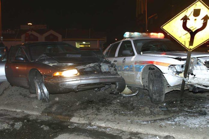 shutterstock_2842305 A damaged car and a police vehicle involved in a nighttime accident