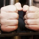 Pastors SCANDAL Ends In Jailhouse SHOCK Hands gripping jail cell bars tightly.