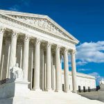 SCOTUS Unexpected RULING Ignites INTEGRITY Firestorm Building with columns under a blue sky.