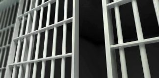Shocking LOOPHOLE Frees TORTUROUS MOM Close-up of prison cell bars.