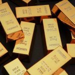 Gold ECLIPSE Rattles Washington Gold bars stacked on dark background