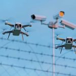 Deported Felon THREATENS World Cup AIRSPACE Two drones flying near security cameras and fence.
