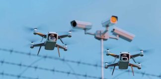 Deported Felon THREATENS World Cup AIRSPACE Two drones flying near security cameras and fence.