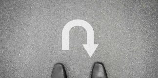 DISGUISED Hitman FLIPS His PLEA Feet in black shoes facing U-turn road marking.