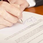 Trump SLAMS DOOR On Landlords! Hand signing a document with a pen.