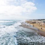 Hottest Nights, 40 DEAD — What Went Wrong? Crowded beach with waves and people enjoying sun.