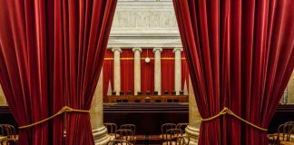 U.S. Supreme Court building under clear blue sky.