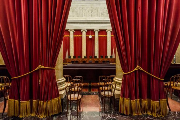 U.S. Supreme Court building under clear blue sky.
