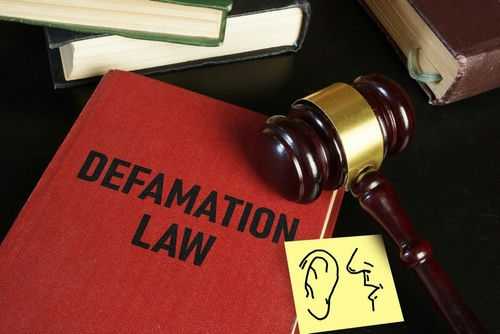 Defamation law book with gavel and illustration