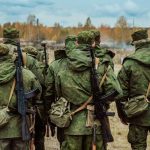 Kremlin DESPERATION — Draft WHISPERS GROW Group of soldiers in camouflage uniforms walking in an outdoor training environment