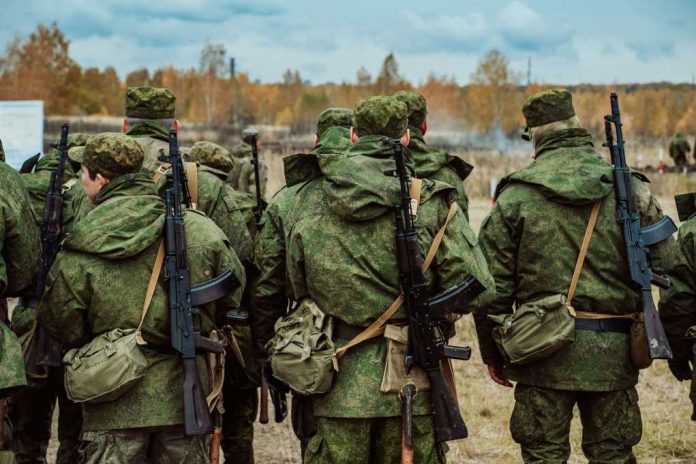 Group of soldiers in camouflage uniforms walking in an outdoor training environment