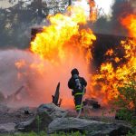 FIREFIGHTERS DEAD — NO Containment Firefighter battling a large fire with water spray