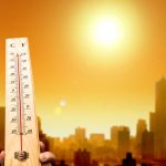 Rare RED Extreme Heat WARNING ISSUED Thermometer displaying high temperature against a sunset city skyline