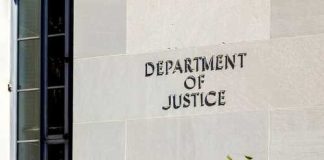 EXPOSED! — Fake US Charity FUNNELED Cash To HAMAS Sign on the exterior wall of the Department of Justice building