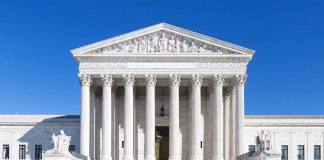 Democracy ‘On Fire’ — Senator DROPS Supreme Court BOMBSHELL The Supreme Court building featuring marble columns and a clear blue sky