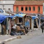 Feds Swarm SKID ROW After Viral STING A street lined with makeshift shelters and a person walking by