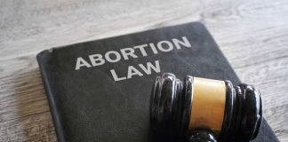 SHOCKING — DISTANT CITY Judges REWRITE Abortion Rules NATIONWIDE! A gavel resting on a book titled 'Abortion Law'