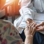 GRIM New York Move Sparks “Throwaway” FEARS A doctor holding the hand of an elderly patient during a consultation