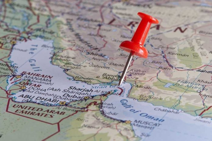 shutterstock_2449365203 A red pushpin on a map of the Middle East highlighting a specific location