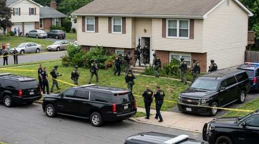 shutterstock_2755604337-1 Law enforcement officers conducting a raid in a residential neighborhood